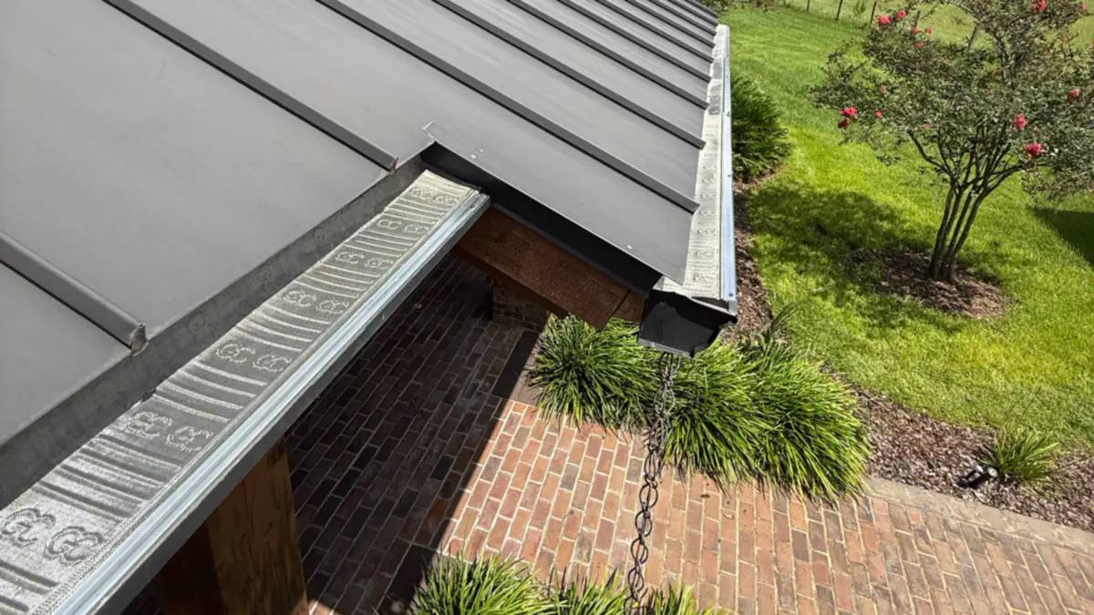 Gutter guards installed on seamless gutters below a standing-seam metal roof in Wahneta, FL
